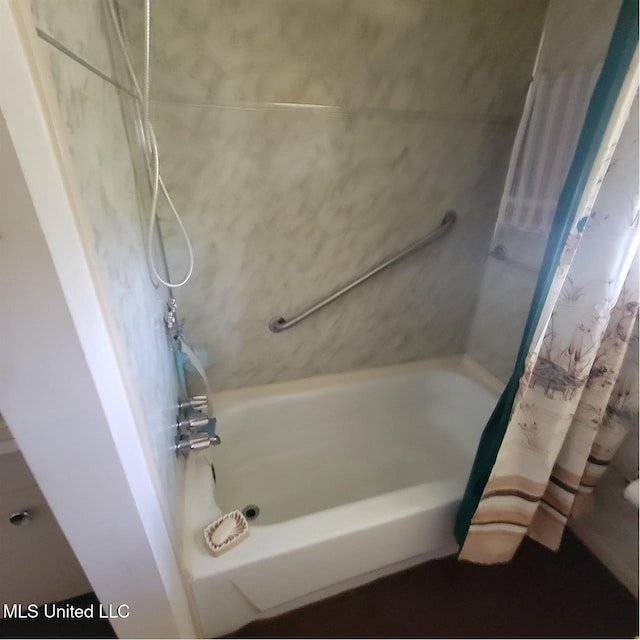 bathroom with shower / bath combo with shower curtain