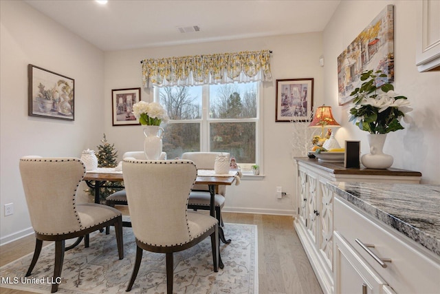 dining area featuring light wood-type flooring