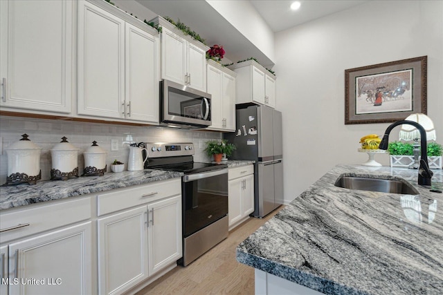 kitchen featuring white cabinets, sink, and stainless steel appliances