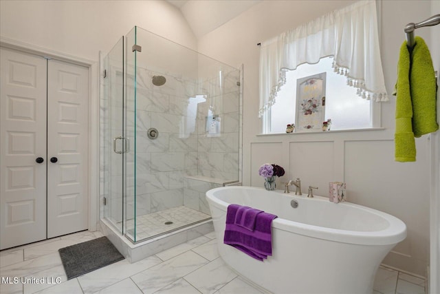 bathroom featuring independent shower and bath and lofted ceiling