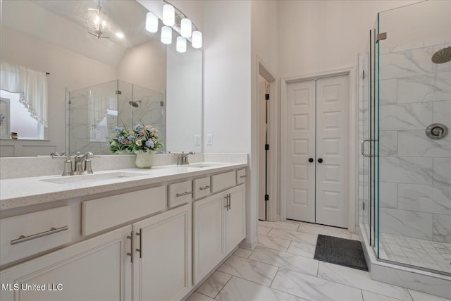 bathroom with vanity and a shower with shower door