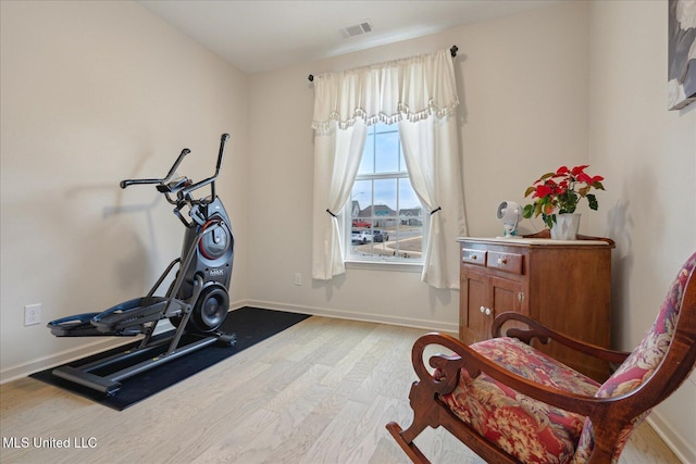 exercise area with light hardwood / wood-style floors