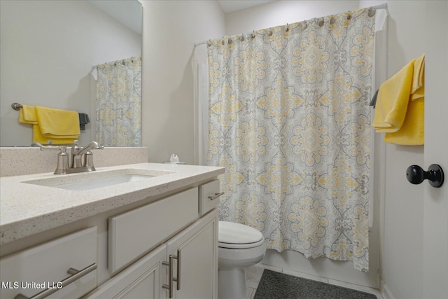 bathroom featuring tile patterned floors, vanity, and toilet