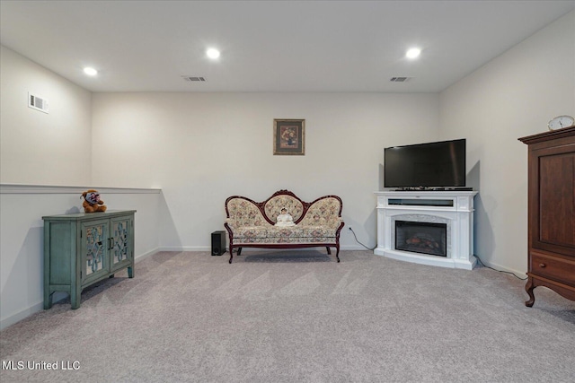 sitting room featuring light colored carpet