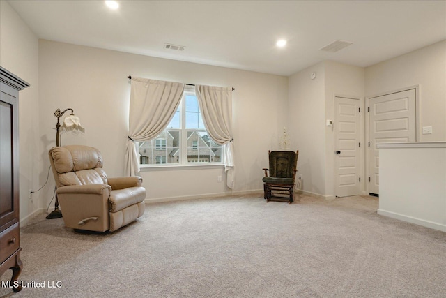 living area with light carpet