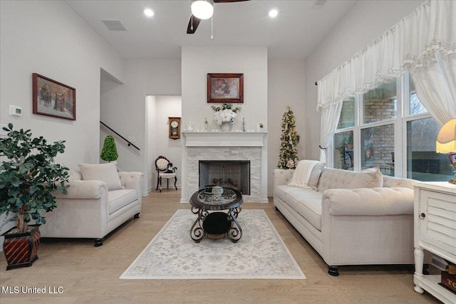 living room featuring ceiling fan and light hardwood / wood-style flooring