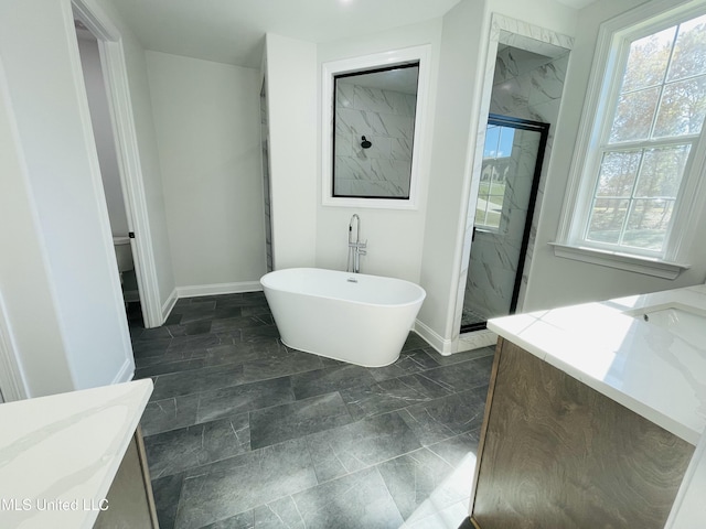 188 E Byhalia Creek Farms Rd, Byhalia, MS 38611 - bathroom with a marble finish shower, vanity, baseboards, and a freestanding bath