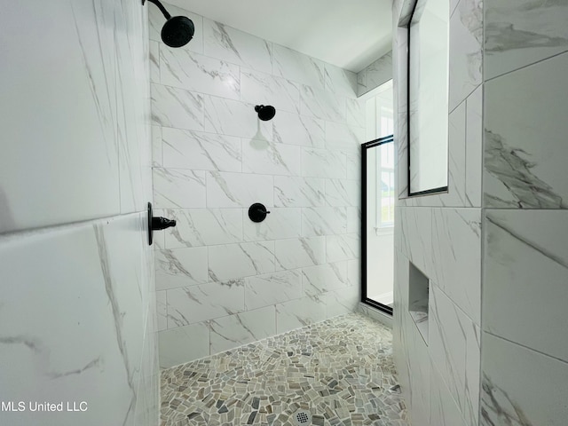 bathroom with tiled shower