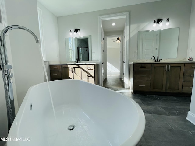 188 E Byhalia Creek Farms Rd, Byhalia, MS 38611 - bathroom with a ceiling fan, a freestanding bath, two vanities, stone finish flooring, and a shower stall