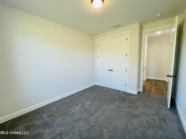 188 E Byhalia Creek Farms Rd, Byhalia, MS 38611 - unfurnished bedroom with dark colored carpet, baseboards, and a closet