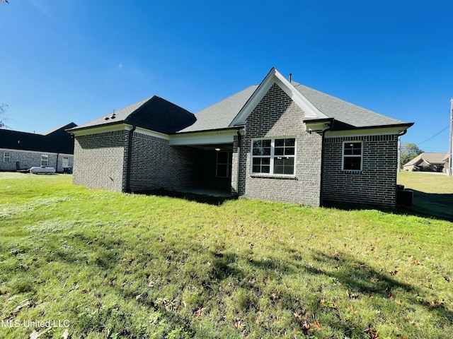 188 E Byhalia Creek Farms Rd, Byhalia, MS 38611 - rear view of property featuring brick siding, a yard, and roof with shingles