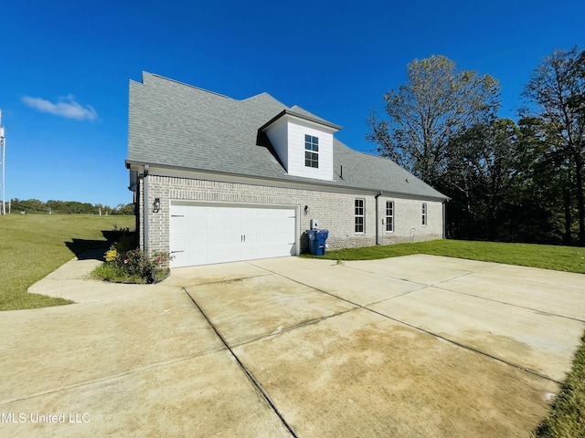 188 E Byhalia Creek Farms Rd, Byhalia, MS 38611 - view of property exterior featuring brick siding, a yard, driveway, and an attached garage