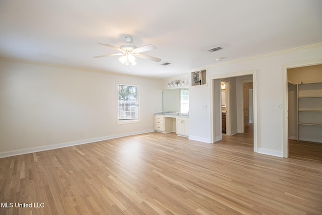 5100 Monroe Ave, Gulfport, MS 39507 - unfurnished bedroom featuring a spacious closet, light wood-type flooring, visible vents, and ornamental molding
