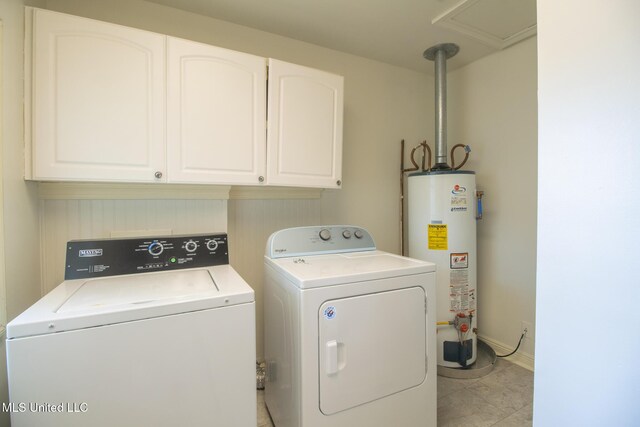 5100 Monroe Ave, Gulfport, MS 39507 - washroom with washing machine and clothes dryer, gas water heater, light tile patterned floors, and cabinet space