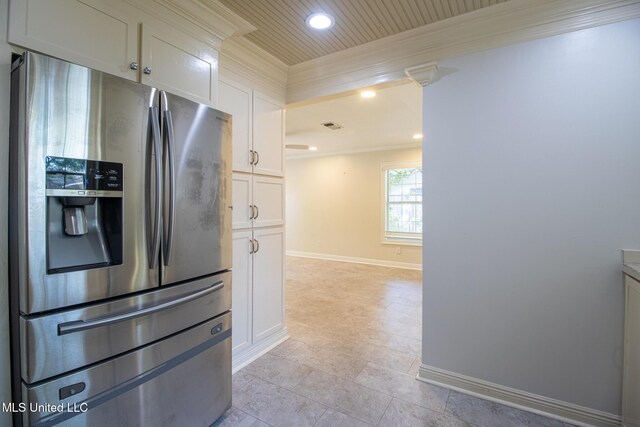 5100 Monroe Ave, Gulfport, MS 39507 - kitchen with baseboards, recessed lighting, white cabinetry, stainless steel fridge with ice dispenser, and ornamental molding