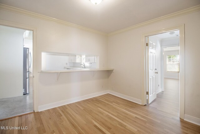 5100 Monroe Ave, Gulfport, MS 39507 - unfurnished room with light wood-style floors, baseboards, ornamental molding, and a sink