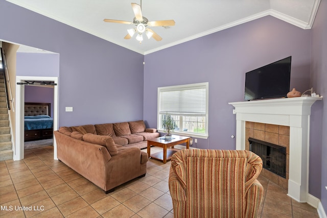 12857 Arbor Dr, Olive Branch, MS 38654 - living room featuring ceiling fan, light tile patterned floors, a fireplace, stairs, and ornamental molding