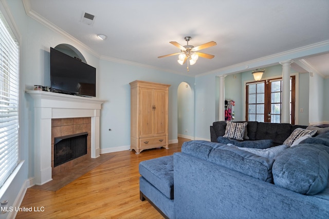 12857 Arbor Dr, Olive Branch, MS 38654 - living area with light wood-style floors, crown molding, a ceiling fan, and a tile fireplace