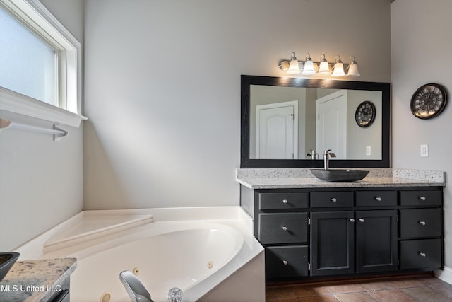12857 Arbor Dr, Olive Branch, MS 38654 - full bath featuring vanity, a jetted tub, and tile patterned flooring
