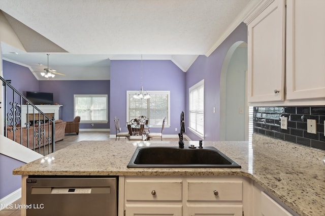 12857 Arbor Dr, Olive Branch, MS 38654 - kitchen featuring stainless steel dishwasher, vaulted ceiling, open floor plan, a ceiling fan, and ornamental molding