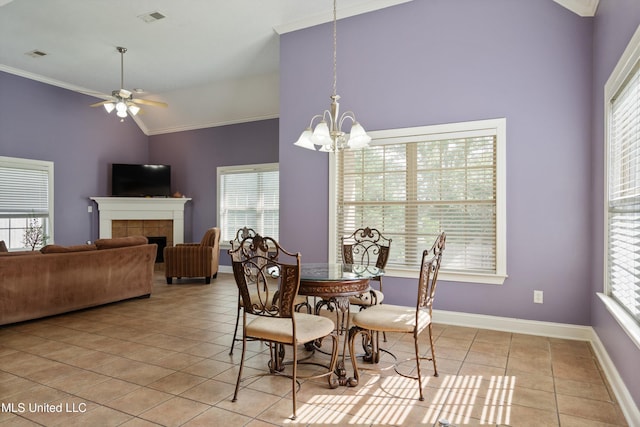 12857 Arbor Dr, Olive Branch, MS 38654 - dining space with tile patterned flooring, crown molding, healthy amount of natural light, a ceiling fan, and a tile fireplace