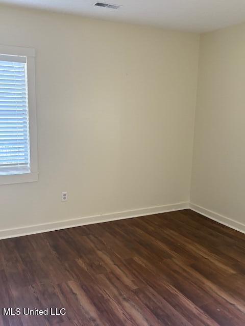 1108 W President Ave, Greenwood, MS 38930 - spare room with dark wood-style floors and baseboards