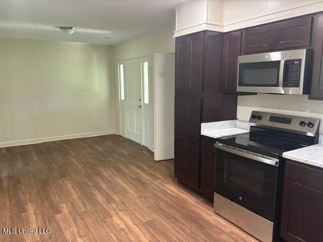 1108 W President Ave, Greenwood, MS 38930 - kitchen featuring appliances with stainless steel finishes, light countertops, dark wood-type flooring, baseboards, and dark brown cabinetry