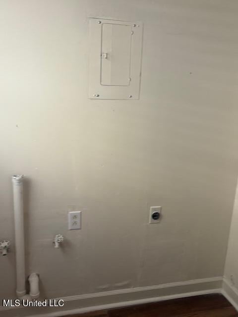 1108 W President Ave, Greenwood, MS 38930 - laundry room with electric panel, baseboards, hookup for an electric dryer, and dark wood-style flooring