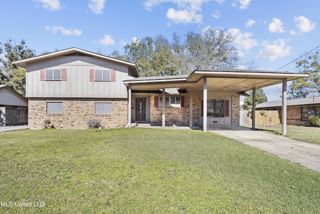 split level home featuring an attached carport, fence, concrete driveway, a front lawn, and brick siding