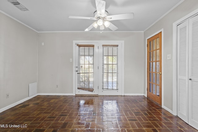 empty room with brick floor, ornamental molding, and baseboards