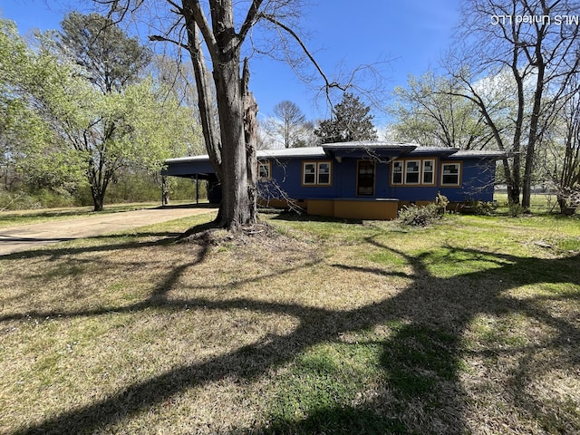 5020 Barrier Pl, Jackson, MS 39204 - view of front facade featuring a carport and a front yard