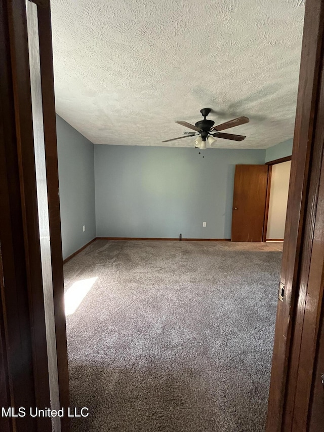 5020 Barrier Pl, Jackson, MS 39204 - carpeted spare room featuring baseboards, a textured ceiling, and a ceiling fan