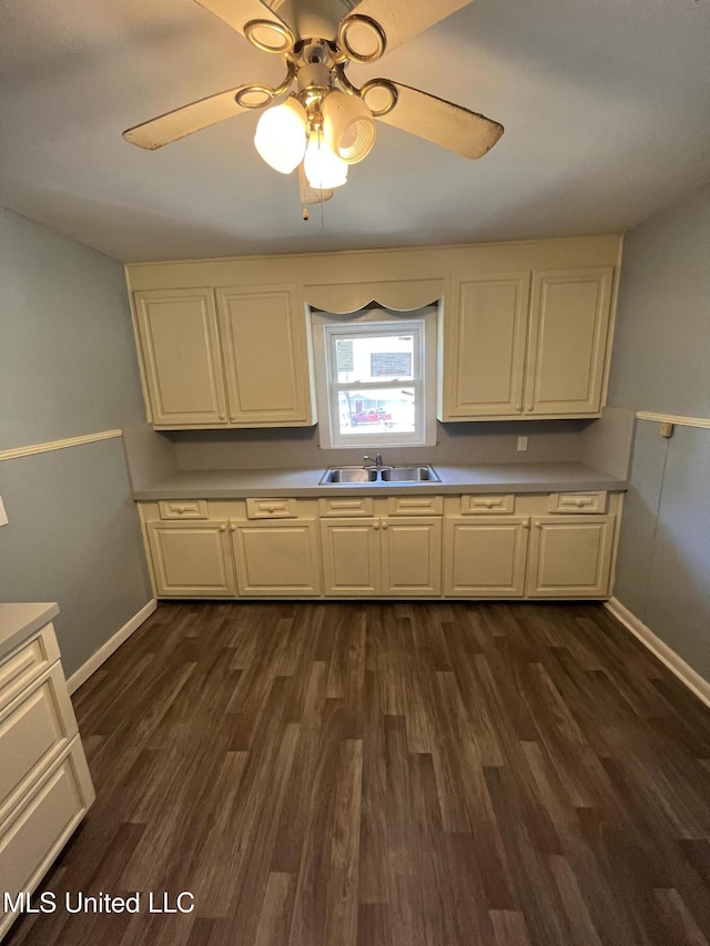 5020 Barrier Pl, Jackson, MS 39204 - kitchen with dark wood-type flooring, a sink, a ceiling fan, and baseboards