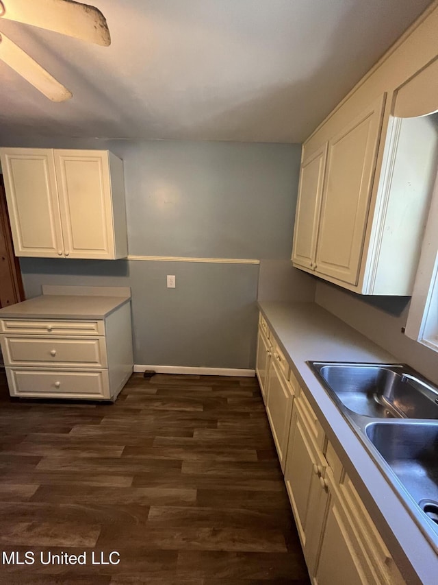 5020 Barrier Pl, Jackson, MS 39204 - kitchen featuring white cabinets, dark wood-type flooring, baseboards, and a sink