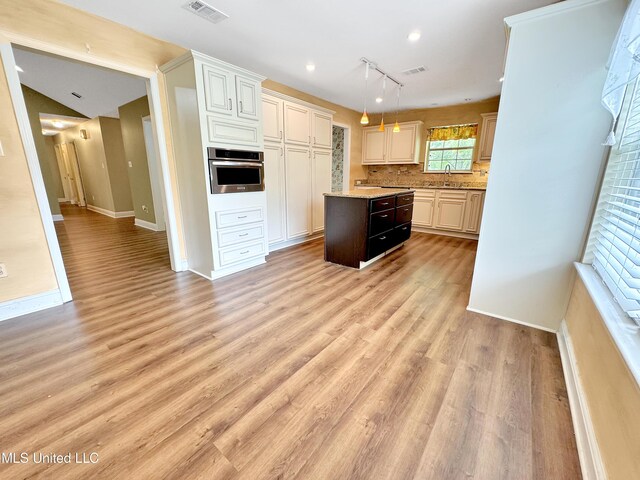 13456 John Clark Rd, Gulfport, MS 39503 - kitchen with oven, a sink, tasteful backsplash, and light wood-type flooring