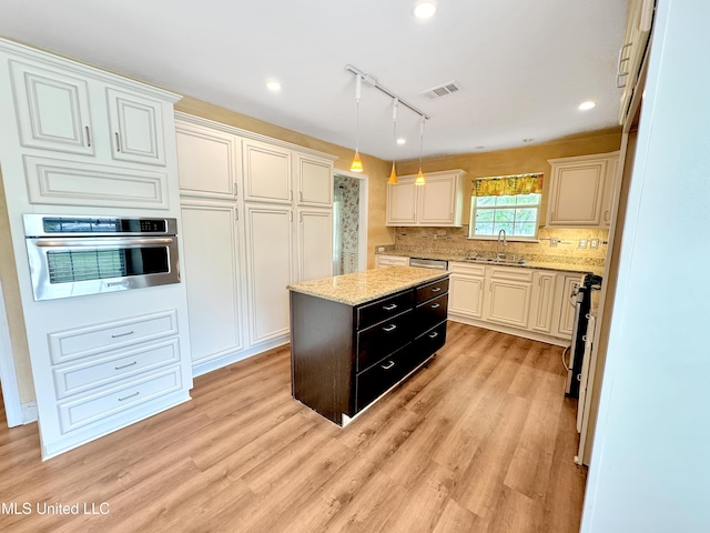 13456 John Clark Rd, Gulfport, MS 39503 - kitchen with stainless steel appliances, a sink, backsplash, decorative light fixtures, and a kitchen island