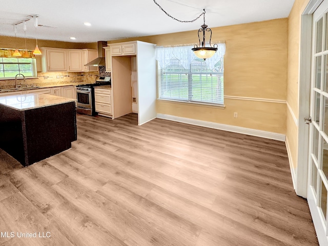13456 John Clark Rd, Gulfport, MS 39503 - kitchen featuring stainless steel gas stove, a sink, wall chimney exhaust hood, decorative light fixtures, and recessed lighting