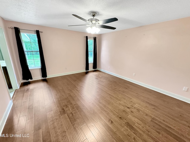 13456 John Clark Rd, Gulfport, MS 39503 - spare room featuring a textured ceiling, wood finished floors, a ceiling fan, and baseboards