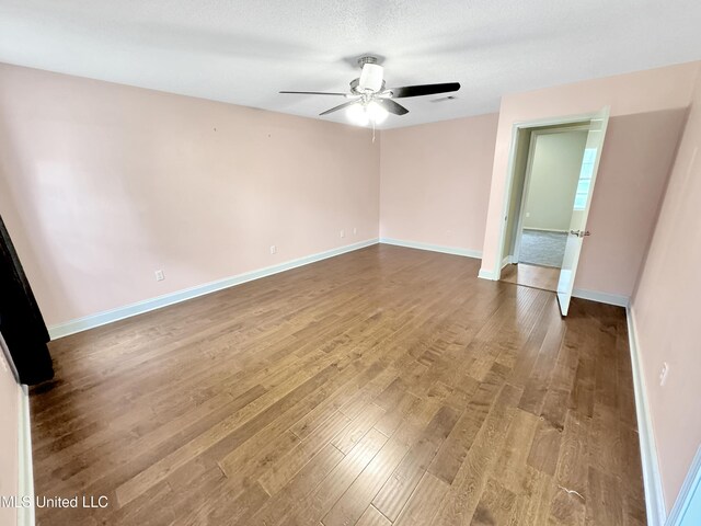 13456 John Clark Rd, Gulfport, MS 39503 - unfurnished room featuring wood finished floors, a ceiling fan, and baseboards