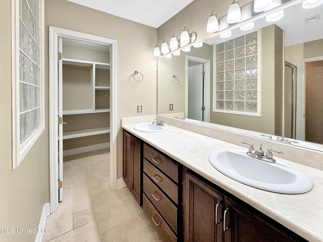 13456 John Clark Rd, Gulfport, MS 39503 - full bath featuring double vanity and tile patterned flooring