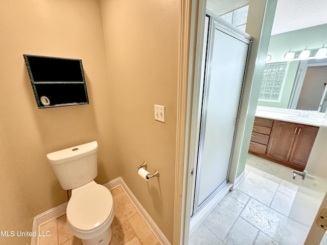 13456 John Clark Rd, Gulfport, MS 39503 - bathroom featuring a stall shower, toilet, vanity, and baseboards
