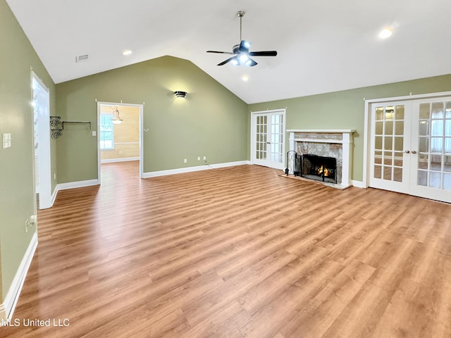 13456 John Clark Rd, Gulfport, MS 39503 - unfurnished living room with french doors, ceiling fan, light wood finished floors, vaulted ceiling, and baseboards