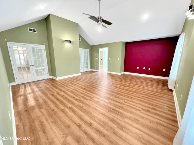 13456 John Clark Rd, Gulfport, MS 39503 - spare room featuring french doors, a ceiling fan, light wood-style flooring, baseboards, and high vaulted ceiling