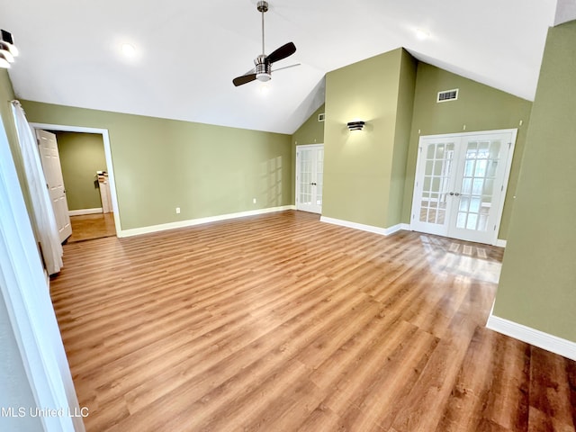 13456 John Clark Rd, Gulfport, MS 39503 - unfurnished living room featuring french doors, ceiling fan, baseboards, wood finished floors, and vaulted ceiling