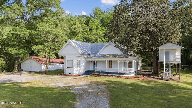 view of front facade with an outbuilding, a porch, crawl space, and a front yard