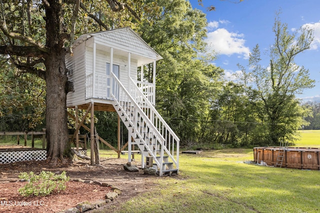 exterior space featuring a hot tub and stairs