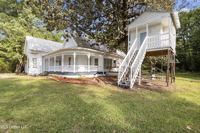 view of front of house featuring covered porch, stairway, and a front lawn