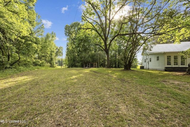 view of yard featuring french doors and entry steps