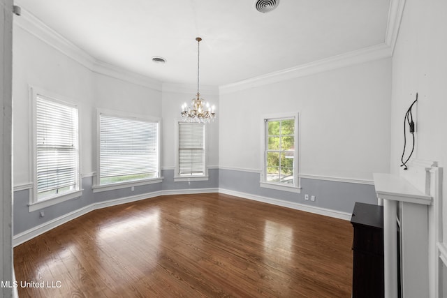 unfurnished dining area with visible vents, crown molding, an inviting chandelier, baseboards, and dark wood-style floors