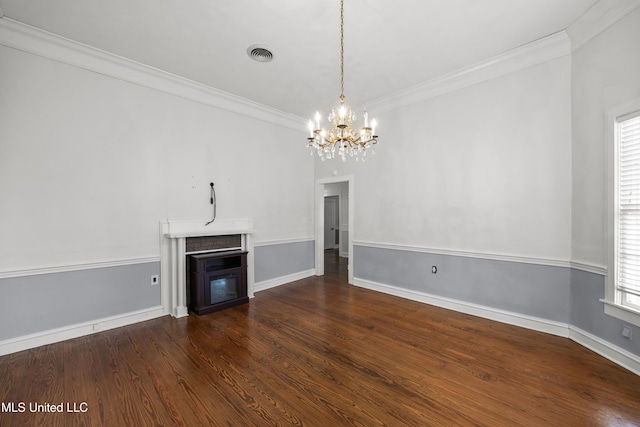 unfurnished living room with an inviting chandelier, crown molding, wood finished floors, and visible vents